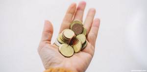 woman holding coins in her hand